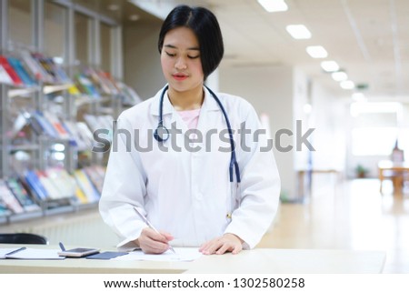 Portrait of a young female doctor in library