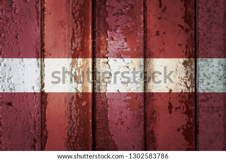 Latvia flag on a grunge plank wood texture for decoration or design