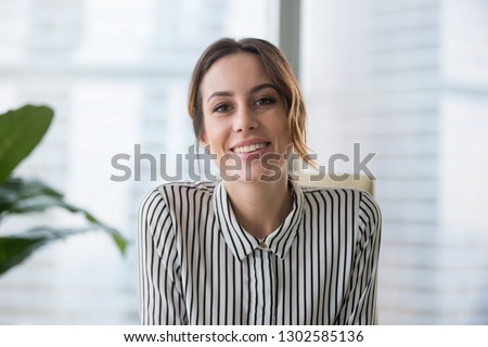 Smiling businesswoman looking at camera webcam make conference business call, recording video blog, talking with client, distance job interview, e-coaching, online training concept, headshot portrait Royalty-Free Stock Photo #1302585136