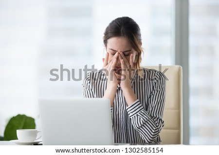 Tired businesswoman massaging eyes feeling strain fatigue headache relieving pain, exhausted female worker suffering from migraine eyestrain after computer work, eyesight problem, overwork concept Royalty-Free Stock Photo #1302585154