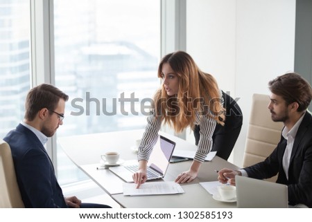 Angry female client customer worker pointing at mistake in business document having complaint demanding change in terms or money compensation detect fraud, business partners contract breach concept Royalty-Free Stock Photo #1302585193