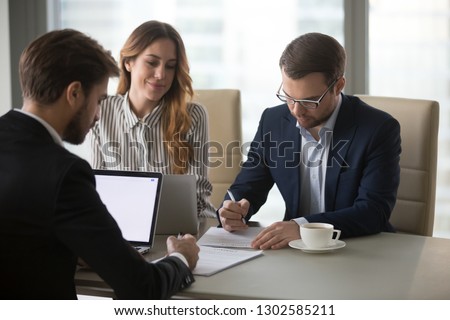 Business partners sign contracts after successful negotiations in office with lawyer mediating, businessmen write signature on legal documents papers make agreement at meeting, franchise concept Royalty-Free Stock Photo #1302585211