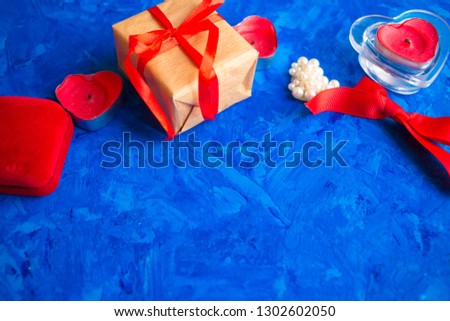 Gift in craft paper with a red ribbon for Valentine's Day, Mother's Day or Christmas