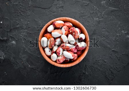 Raw beans in a bowl. Top view. Free copy space.