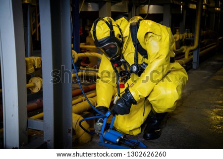 Rescuers in a radiation protection suit. Royalty-Free Stock Photo #1302626260