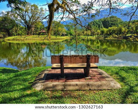 Taiping Lake Gardens is located in Malaysia and one quarter of the country's tourist attractions. Image shows a small bridge in the park's lakes. Reflection in water.