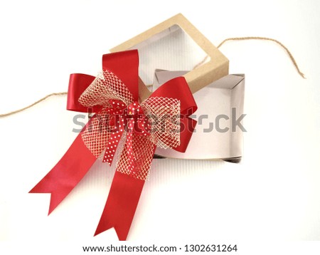 Open and empty white gift Box with red ribbon bow on white background.isolate image top view.