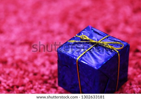 Christmas gifts box decorative closeup on pink texture blur background
