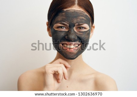 joyful woman with a smile on her face clay mask portrait