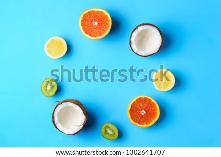 summer vacation, cocktail, tropical beach. creative layout of exotic fruits, banner or poster template with copy space for text design. lemon, orange, kiwifruit, coconut on blue background