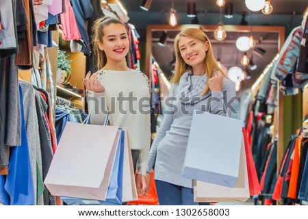 Happy women with shopping bags in the store