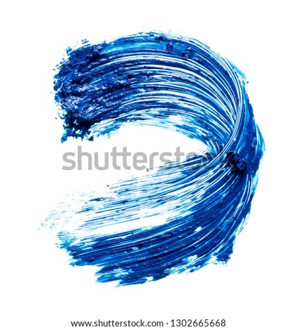 Smear of navy blue mascara for eyelashes or acrylic paint isolated on white background.