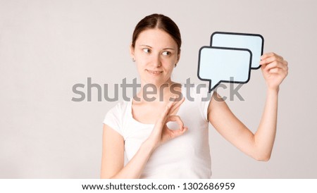Girl holding blank sign. Portrait of an excited woman holding blank speech bubble