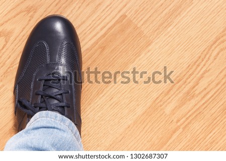 Navy blue comfortable leather shoe for men on wooden background, copy space for inscription