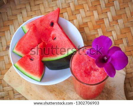 Top view watermelon smoothies juice in glass and watermelon fresh isolate on wood tray background