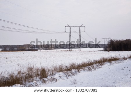 High-voltage power lines laid across the snow-covered expanses of Russia