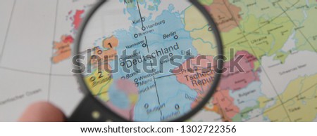 a world map with Germany under the magnifying glass
