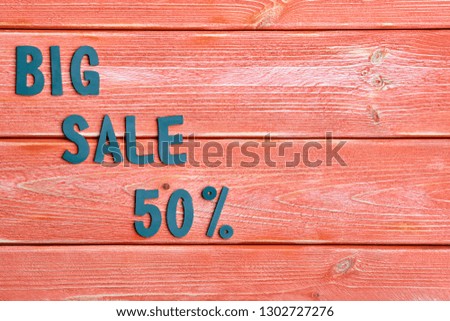 big sale lettering and discount offer at 50 percent, metal letters on textured wooden boards color season 2019, close up, top view, flat lay