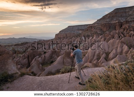 Photographer taking picture at sunset in Cappadocia