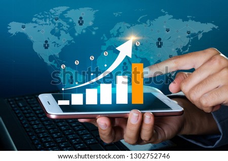 Graph of financial growth global communications Binary Smart Phones and world Internet Business people press the phone to communicate in the Internet Stock chart Researching process.business Team 