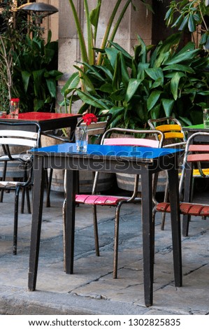 Street cafe with colorful tables and chairs in Barcelona, Spain