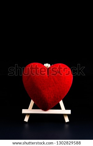 Valentine's day Concept heart shape on Wooden stand on black background and empty space for your graphic. Reminder for couples to express love