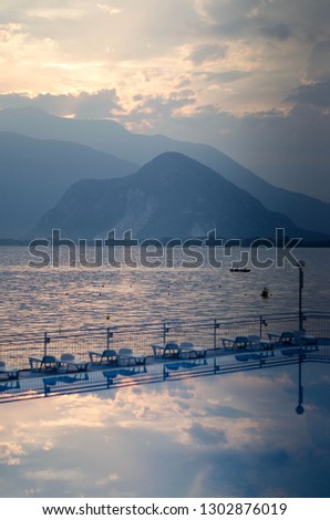 North Italy. Maggiore Lake.  sunset. pool with chaise lounges. Picturesque view 