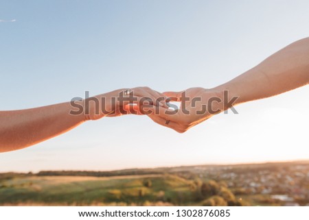 hands of lovers are drawn to each other