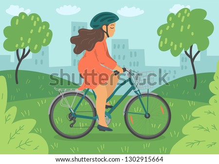 Woman in helmet on bike with basket. Woman cycling in the city park.