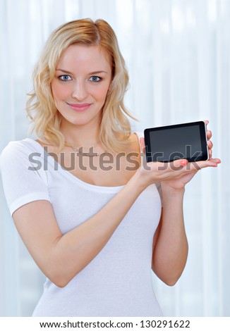 Portrait of a beautiful young woman holding a tablet PC