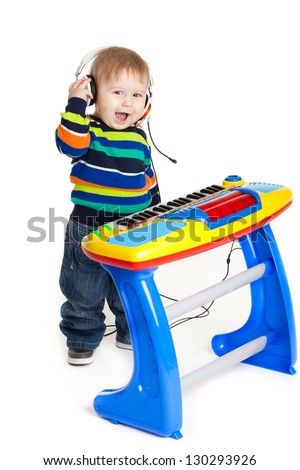 little boy and the keyboard on white background. funny boy baby. young DJ