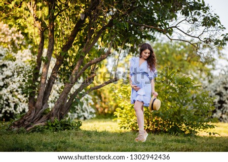 Summer mood. Romantic girl in Provence image and straw hat near beautiful tree. Spring or summer coming. Spring story. Brown-haired girl with long hairs.