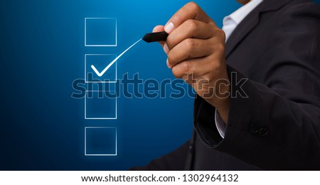 Business man with pen mark the checkbox,Check the accuracy