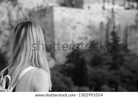 girl looks at the fortress for text black and white photo
