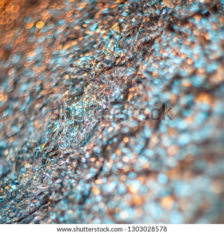 Abstract blur and defocused crumpled foil texture for background. Artistic colorful bokeh. Toned image does not focus. Pattern for poster, print. 