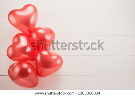 Red heart balloons on a white background
