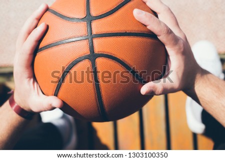Man holds the ball for basketball