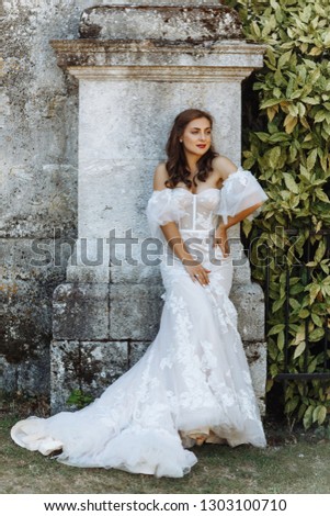 Perfectly beautiful young bride poses in a luxurious white dress on her happiest day