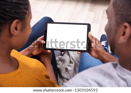 Close-up Of A Couple Holding Digital Tablet With Blank White Screen
