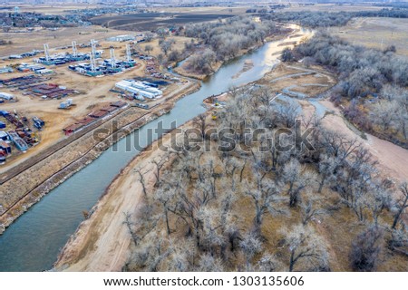 Industrial and farming landscape along South Platte River near LaSalle, Colorado, aerial view