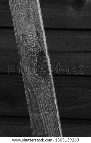 Frost covered cedar red stained wood showing textures and patterns produced by cold winter weather