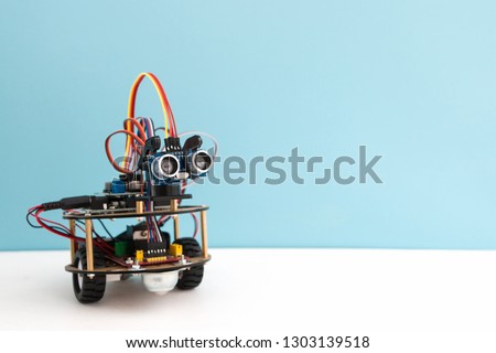 Hand made robot working on the arduino platform. White background. Free space for text. STEM education for children and teenagers, robotics and electronics. DIY. AI. STEAM. Royalty-Free Stock Photo #1303139518