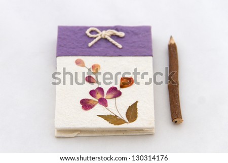 Handmade notebook and pencil isolated on white background