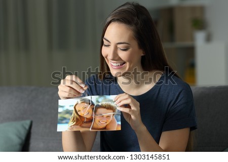 Woman rebuilding couple photo after reconciliation sitting on a couch in the living room at home