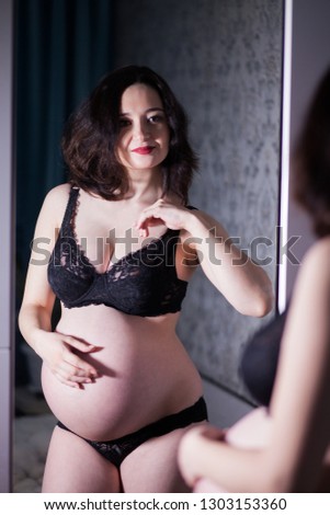 Pregnant woman in front of mirror 