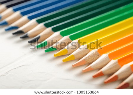 colored pencils on a white background close-up in macro photography. art set of pencils with free space.