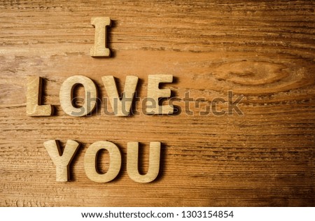 i love you - inscription made from wooden letters. wood background. 