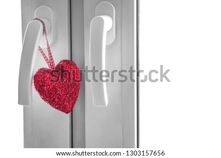 red sugar  Heart hangs on a glass window or Door. The concept of love and the holiday of St. Valentine's Day.