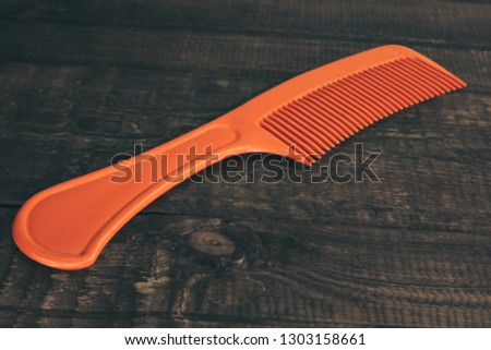 red hairbrush on a black background subject background