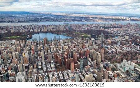 Aerial view of Manhattan skyline from the sky on a cloudy day, New York City.